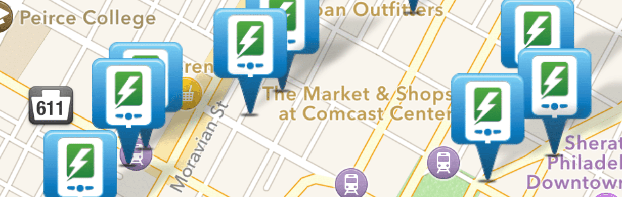 A map image highlighting multiple electric vehicle charging stations indicated by green and white lightning bolt icons. The map shows prominent locations such as "The Market & Shops at Comcast Center," "Sheraton Philadelphia Downtown," and "Peirce College.